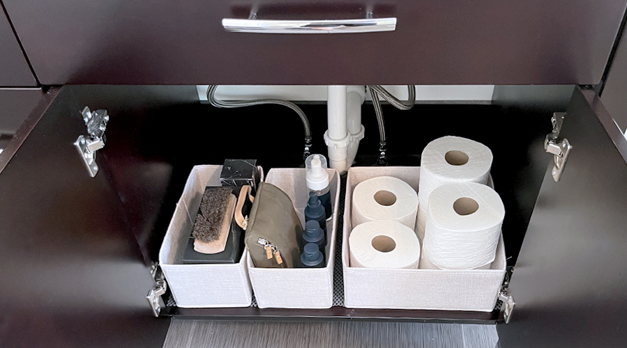 Use fabric storage bins to organize belongings in your bathroom vanity