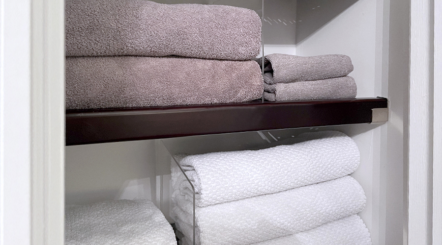 Use shelf dividers to organize towels in your bathroom