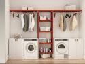 A modern, organized laundry room with a John Louis Home laundry organizer filled with storage bins, laundry cleaning items, towels and clothes hanging neatly above two white washing machines.