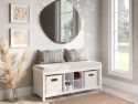 Solid wood white entryway bench with tweed cream cushion, 2 storage bins and a shoe cubby decorated with throw pillows in a beautifully decoded foyer