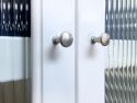 Two John Louis Home fluted glass doors with satin nickel doorknobs, highlighting glass surface