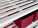 A close up featuring the ventilated shelf of a solid wood stackable shoe and shelving rack