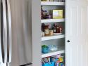 An open pantry revealing neatly organized shelves of food using wire shelf covers