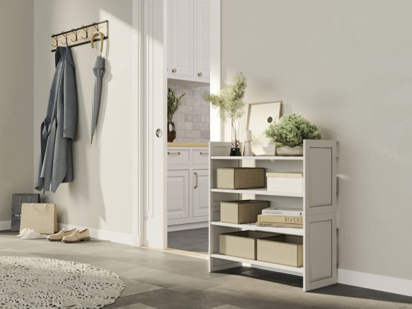 A 2 tiered stackable storage shelf with baskets, decor items and books, creating a neat and organized storage solution displayed in the hallway of a refreshing home.