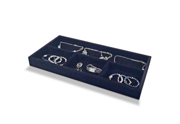 A rectangular black velvet John Louis Home organizer valet tray containing a variety of silver jewelry including necklaces, rings, and bracelets, each placed in separate compartments, on a white background.