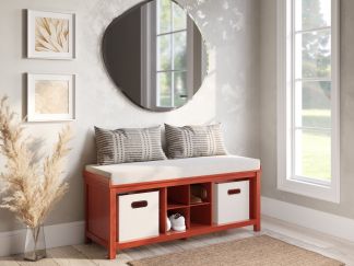 Solid wood entryway bench with tweed cream cushion, 2 storage bins and a shoe cubby decorated with throw pillows in a beautifully decoded foyer