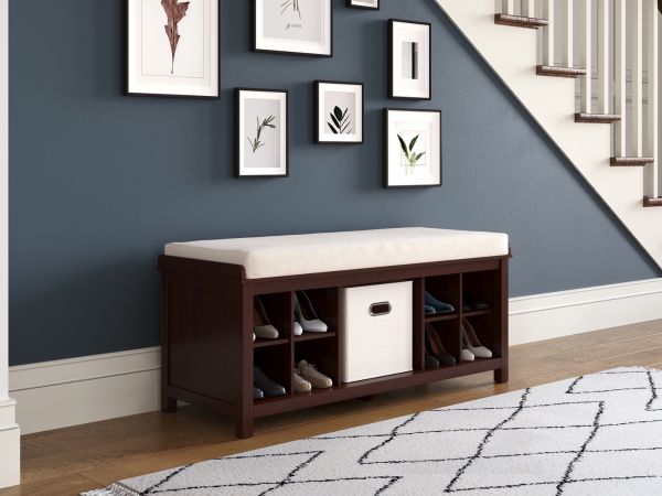 Solid wood entryway bench with 2 shoe cubbies and one storage bin cubby with Crean tween fabric storage bin and memory foam cushion placed in a stairway hallway with contemporary decor.