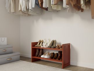 A neatly organized closet with a variety of shoes easily accessible on a solid wood shoe rack and clothes hanging on the wall.