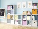 Multiple 4 cube organizers used to create a complete storage solution for kids toys, books and crafts in a colorful kids playroom