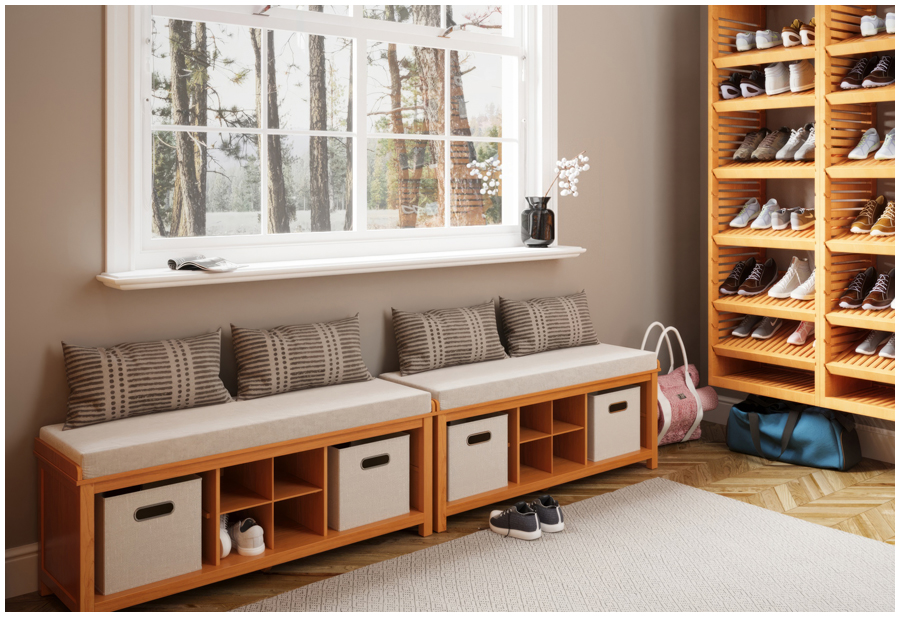 A wooden shoe storage bench under a window in a walk in shoe closet.