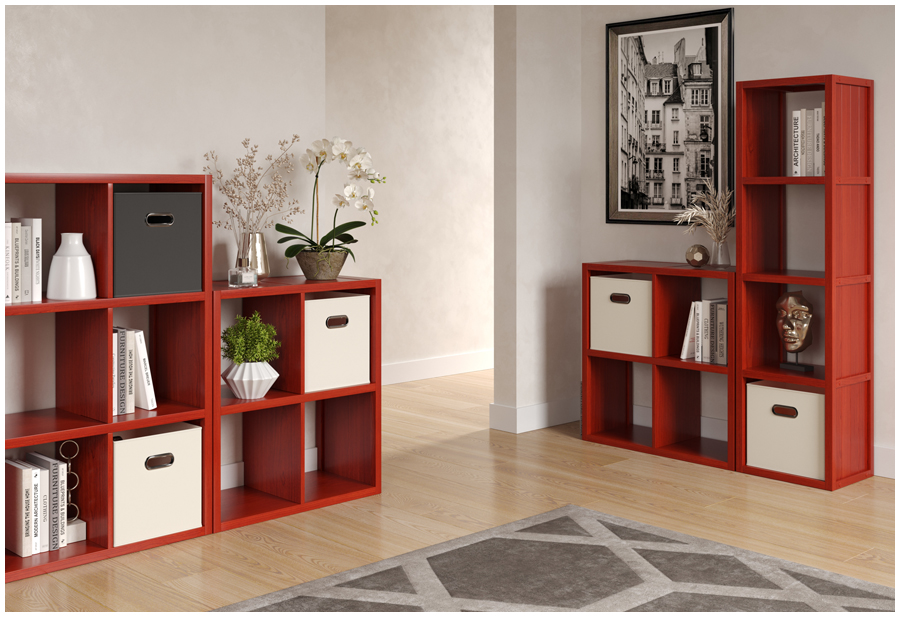 A living room with red wooden storage cubes and shelves lining the walls. A painting with colorful shapes hangs on the back wall.