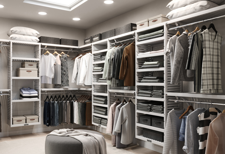 A customer's spacious walk-in closet featuring a variety of clothing items, footwear, and accessories, including a cushioned wooden ottoman designed by John Louis Home.