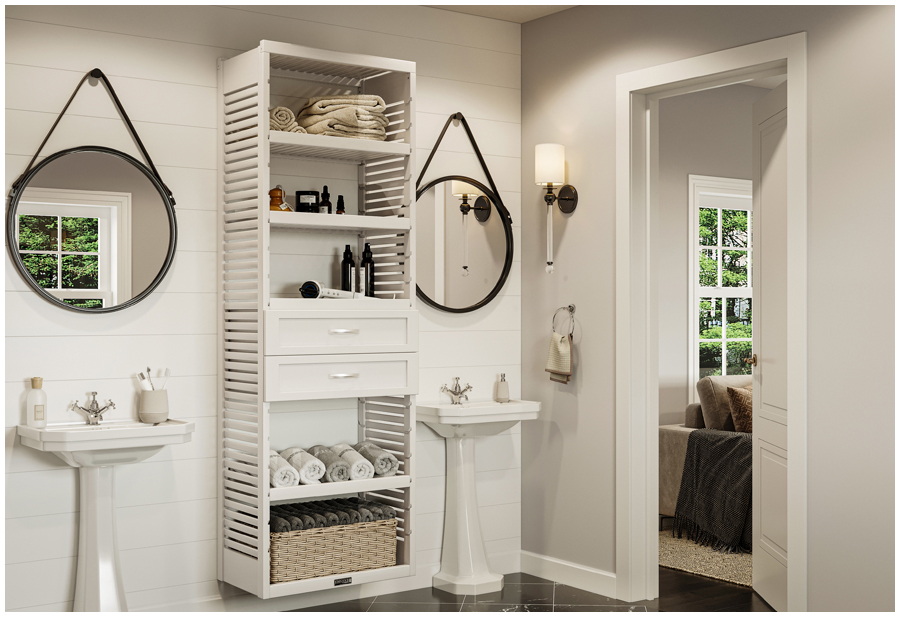 Two pedestal sinks in a chic country style bathroom with a storage tower organizer with shelves and drawers in between