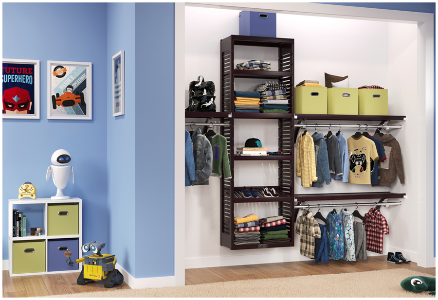 An organized children's closet displaying folded clothes, toys and storage bins