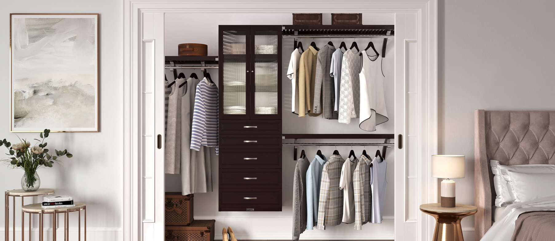 John Louis Home wood closet system with hanging rods, shelves, glass doors and drawers, filled with clothes in a bedroom