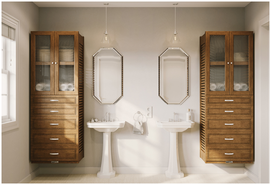 A bathroom with two pedestal sinks and a storage organizer tower with drawers and glass doors on each side