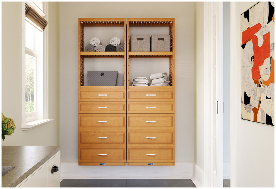 A mudroom entryway with organized solid wood storage towers and drawers on the backwall