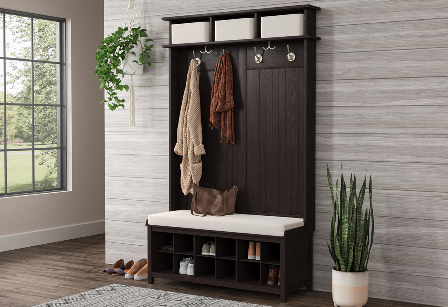 Tidy and neat entryway featuring solid wood hall tree shoe bench displaying various coats, hats, scarves and shoes neatly organized.